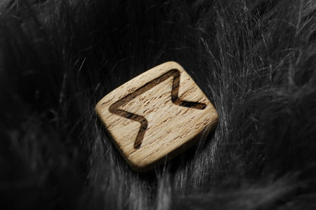 Wooden rune Perth on gray faux fur, closeupの写真素材