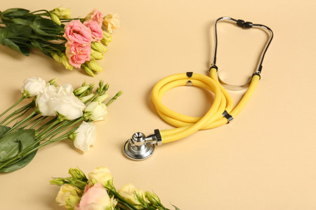 Stethoscope and eustoma flowers on beige background. Happy Doctor's Dayの写真素材