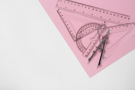 Different rulers and compass on color background. Space for textの写真素材