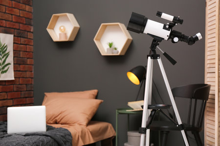 Tripod with modern telescope in stylish room. Space for textの写真素材