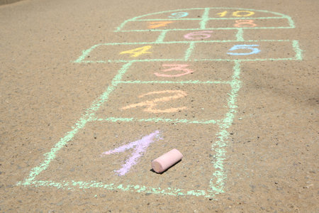 Hopscotch drawn with colorful chalk on asphalt outdoors, closeupの写真素材