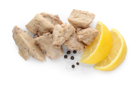 Tasty cod liver with lemon slices on white background, top view