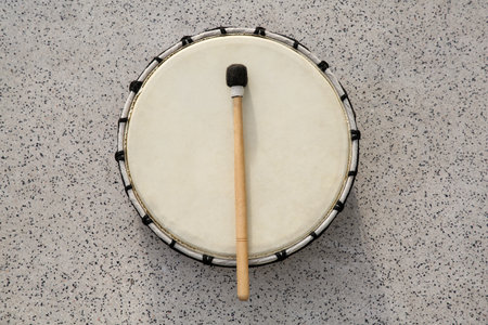 Drum and drumstick on gray table, top view. Percussion musical instrumentの写真素材