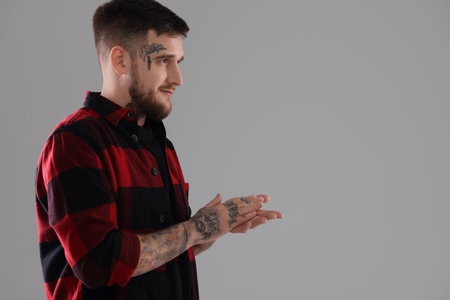 Handsome hipster man on light grey background. Space for textの写真素材