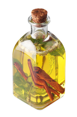 Glass bottle of cooking oil with spices and herbs isolated on whiteの写真素材