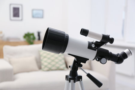Tripod with modern telescope in stylish room, closeupの写真素材