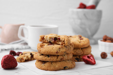 Cookies with freeze dried fruits and nuts on white marble table, closeup