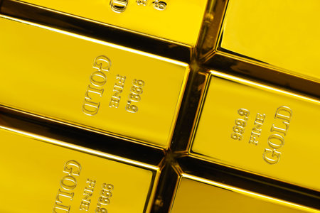 Many shiny gold bars as background, top view