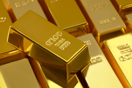Many shiny gold bars as background, closeup