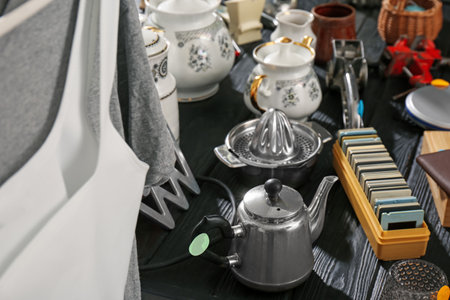 Many different stuff on black wooden table. Garage saleの写真素材