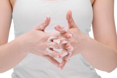 Woman with cleansing foam on hands against white background, closeupの写真素材