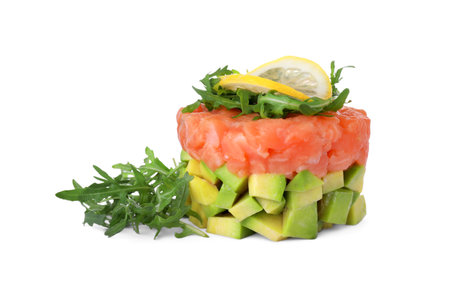 Tasty salmon tartare with avocado, lemon and arugula isolated on whiteの写真素材