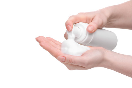 Woman applying cleansing foam onto hand on white background, closeupの写真素材