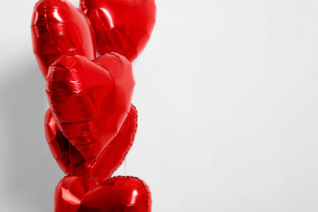 Many red heart shaped balloons on white background, closeup. Space for textの写真素材