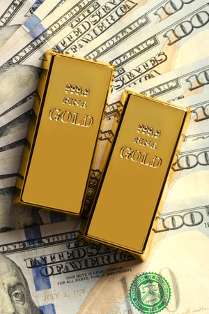 Shiny gold bars on dollar banknotes, flat layの写真素材