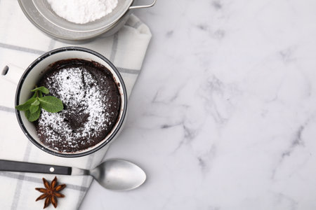 Tasty chocolate mug pie on white marble table, flat lay with space for text. Microwave cake recipe