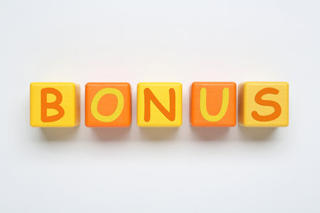 Word Bonus made of color cubes with letters on white background, top view