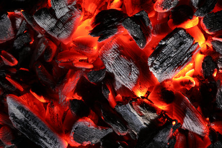 Pieces of hot smoldering coal as background, top viewの写真素材