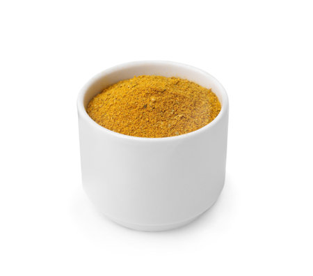 Bowl with curry powder isolated on whiteの写真素材