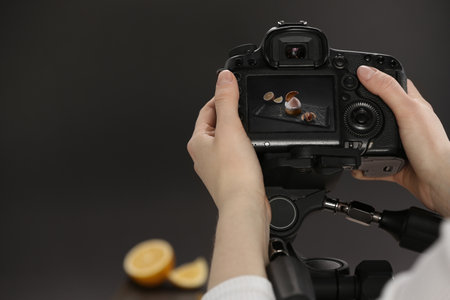 Food stylist taking photo of delicious dessert in studio, closeup. Space for textの写真素材
