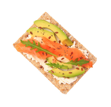 Fresh crunchy crispbread with cream cheese, salmon, avocado and arugula isolated on white, top viewの写真素材