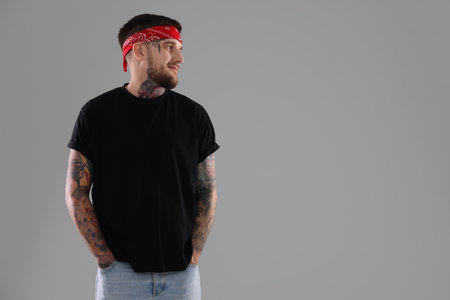 Handsome hipster man on light grey background. Space for text