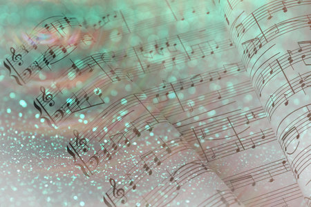 Double exposure of sheets with music notes and green glitter as background, bokeh effectの写真素材