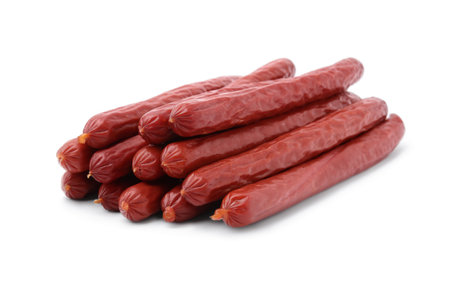 Many delicious smoked sausages isolated on whiteの写真素材