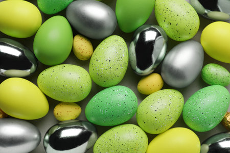 Many painted Easter eggs on gray background, flat layの写真素材