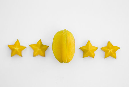 Delicious cut and whole carambolas on white background, top viewの写真素材
