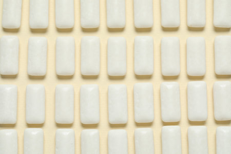 Tasty white chewing gums on beige background, flat layの写真素材
