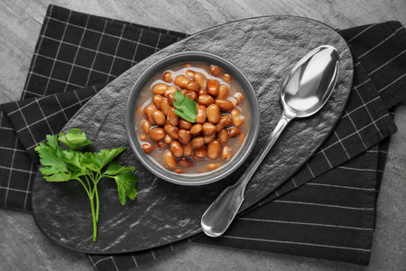 Tasty canned kidney beans with parsley served on gray table, top viewの写真素材