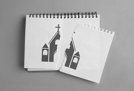 Atheism as religious position. Torn paper with illustration of church in notebook on gray background, top viewの写真素材