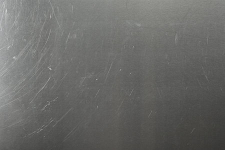 Old metal surface with scratches as background, closeupの写真素材
