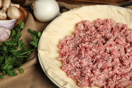 Raw dough and ingredients on napkin, closeup. Baking meat pieの写真素材