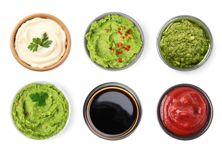 Set of guacamole and different sauces on white background, top viewの写真素材