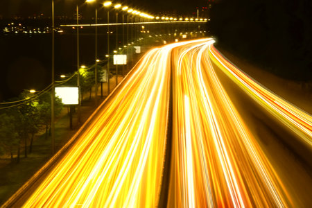 Road traffic, motion blur effect. View of car light trails at nightの写真素材