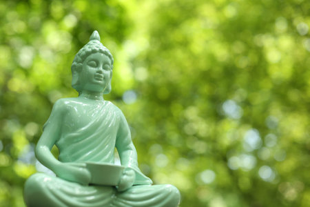 Decorative Buddha statue on blurred background, closeup. Space for textの写真素材