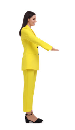 Beautiful businesswoman in yellow suit on white backgroundの写真素材