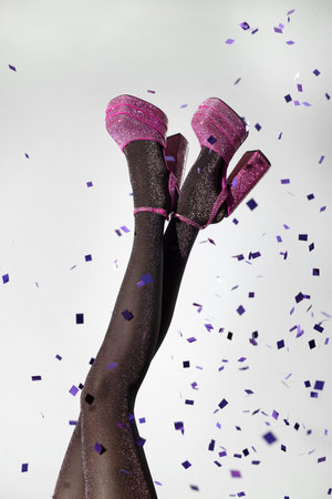 style party. Woman wearing pink high heeled shoes with platform and square toes on light gray background, closeupの写真素材