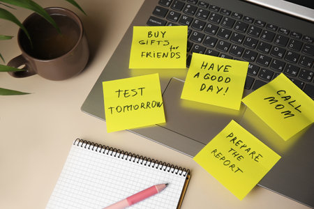 Many different reminder notes and laptop on white table, above view