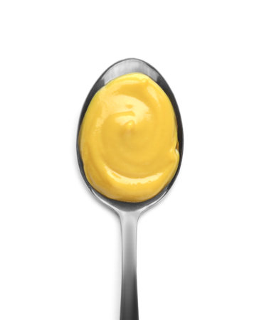 Spoon with delicious mustard on white background, top viewの写真素材