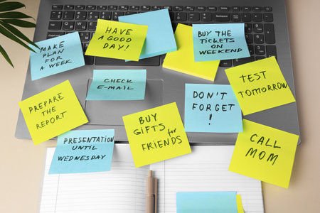 Different reminder notes and laptop on white tableの写真素材
