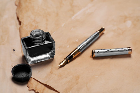 Inkwell and fountain pen on vintage parchment