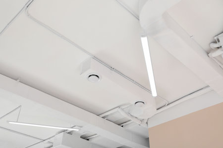 White ceiling with modern lighting in room, low angle view