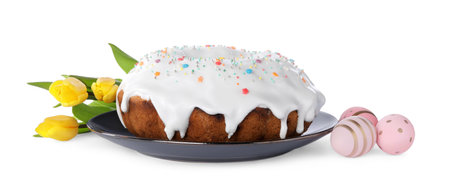 Easter cake with sprinkles, yellow tulips and decorated eggs isolated on white