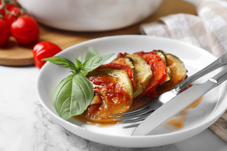 Delicious ratatouille served with basil on white marble table, closeupの写真素材