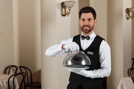 Man setting table in restaurant. Professional butler courses