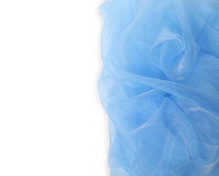 Beautiful light blue tulle fabric on white background, top view. Space for textの写真素材