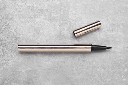 Eyeliner marker on light gray table. Makeup product